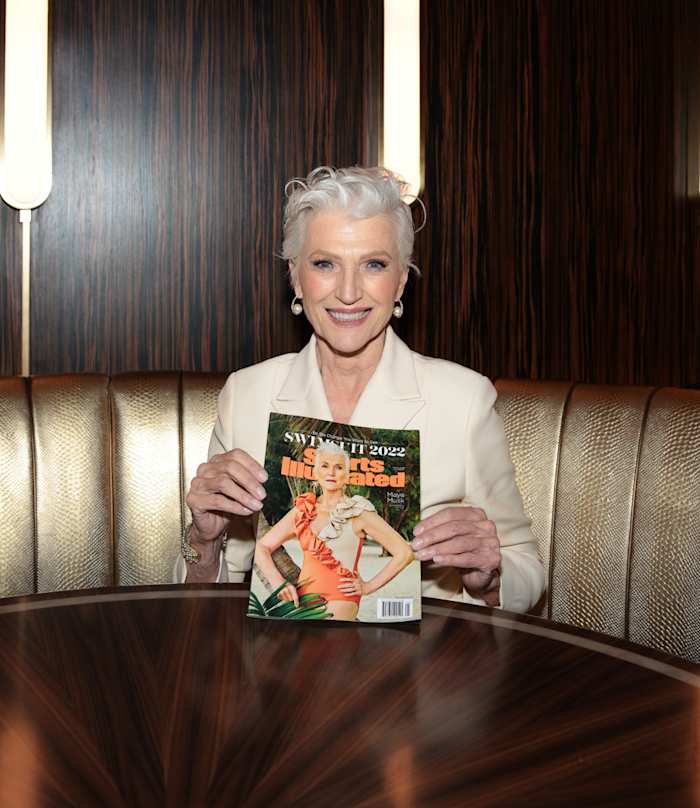 Maye Musk holds her cover issue of SI Swimsuit 2022.